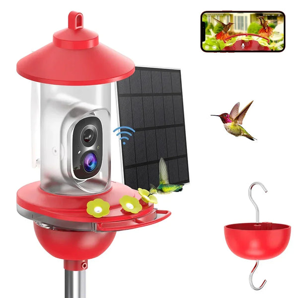 Red hummingbird feeder with solar panel, camera, and hanging hook on a white background.